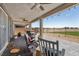 Inviting covered patio with brick flooring, ceiling fans, and views of the green golf course at 4557 E Cactus Canyon Dr, Pahrump, NV 89061