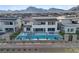 Aerial view of a home with a backyard pool, spa, and patio with mountain backdrop at 472 Windstone Crest Ave, Las Vegas, NV 89138