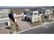 Aerial view of a modern two-story home with a three-car garage and landscaped front yard at 472 Windstone Crest Ave, Las Vegas, NV 89138