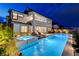 Inviting backyard featuring a sparkling pool, hot tub, and lounge chairs, perfect for outdoor relaxation at 472 Windstone Crest Ave, Las Vegas, NV 89138