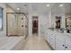 The spacious bathroom offers dual vanities, a soaking tub, walk in shower, and closet access at 472 Windstone Crest Ave, Las Vegas, NV 89138