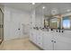 The modern bathroom boasts double sinks, a walk-in shower, and stylish fixtures at 472 Windstone Crest Ave, Las Vegas, NV 89138