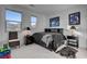 Bedroom with dark furniture and bedding plus mountain views from the windows at 472 Windstone Crest Ave, Las Vegas, NV 89138