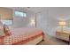 Bedroom with a patterned bedspread, side tables with lamps, and a sliding door closet at 472 Windstone Crest Ave, Las Vegas, NV 89138