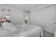 Well-lit bedroom showcasing neutral tones, a comfortable bed, and closet with sliding doors at 472 Windstone Crest Ave, Las Vegas, NV 89138