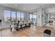 Modern dining area featuring a dark wood table, seating for six, and sliding glass door to the backyard at 472 Windstone Crest Ave, Las Vegas, NV 89138
