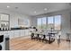 Contemporary dining area with large windows, stylish table, and chairs with view of the backyard at 472 Windstone Crest Ave, Las Vegas, NV 89138