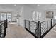 Bright hallway with modern railings, carpeted floors, and natural light from large windows at 472 Windstone Crest Ave, Las Vegas, NV 89138