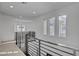Bright hallway with modern railings, carpeted floors, and natural light from windows at 472 Windstone Crest Ave, Las Vegas, NV 89138