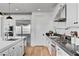 Modern kitchen featuring stainless steel appliances, white cabinetry, and elegant countertops at 472 Windstone Crest Ave, Las Vegas, NV 89138