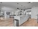 Modern kitchen featuring a large island, stainless steel appliances and an open floor plan into the living room at 472 Windstone Crest Ave, Las Vegas, NV 89138