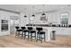 This bright kitchen features sleek white cabinets, stainless steel appliances, and a spacious island at 472 Windstone Crest Ave, Las Vegas, NV 89138