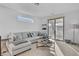 Cozy living room with a large sectional sofa, access to a balcony, and ample natural light at 472 Windstone Crest Ave, Las Vegas, NV 89138