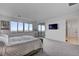 The spacious main bedroom includes carpeted floors, large windows, and access to the balcony at 472 Windstone Crest Ave, Las Vegas, NV 89138