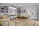 Bright office space with a built-in bookcase, light wood floors and minimalist decor at 472 Windstone Crest Ave, Las Vegas, NV 89138