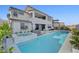 Backyard view showcasing a pool, spa, and modern two-story house exterior at 472 Windstone Crest Ave, Las Vegas, NV 89138