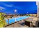 Relaxing backyard with rectangular pool, elevated spa, lounge chairs and landscape lighting at 472 Windstone Crest Ave, Las Vegas, NV 89138