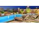 Backyard features a large rectangular pool, elevated spa, lounge chairs and mature landscaping at 472 Windstone Crest Ave, Las Vegas, NV 89138