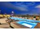 Backyard features a large rectangular pool, elevated spa, and lounge chairs at 472 Windstone Crest Ave, Las Vegas, NV 89138