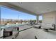 Covered patio boasts poolside lounge area with comfortable seating and scenic views at 472 Windstone Crest Ave, Las Vegas, NV 89138