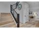 Contemporary staircase featuring wood steps, black metal railing, and bright white walls at 472 Windstone Crest Ave, Las Vegas, NV 89138