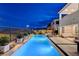 Elegant pool with landscaped surroundings, outdoor seating area, and scenic mountain views at 472 Windstone Crest Ave, Las Vegas, NV 89138