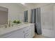 Bathroom features a dual sink vanity with white cabinets and shower with curtain at 5033 Wild Buffalo Ave, Las Vegas, NV 89131