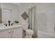Bathroom featuring a white vanity, toilet, shower with printed shower curtain and neutral tile flooring at 5033 Wild Buffalo Ave, Las Vegas, NV 89131