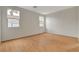 Bedroom featuring wood-look flooring, two windows, and light colored walls at 5033 Wild Buffalo Ave, Las Vegas, NV 89131