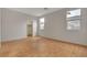 Bedroom featuring wood-look flooring, two windows, and view of closet at 5033 Wild Buffalo Ave, Las Vegas, NV 89131