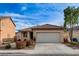 Charming single-story home features a well-maintained front yard, two car garage and neutral color palette at 5033 Wild Buffalo Ave, Las Vegas, NV 89131