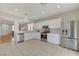 Bright kitchen features stainless steel appliances, white cabinets, and tile flooring at 5033 Wild Buffalo Ave, Las Vegas, NV 89131