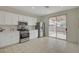 Bright kitchen with stainless steel appliances and sliding glass doors to backyard at 5033 Wild Buffalo Ave, Las Vegas, NV 89131