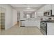 Bright kitchen with stainless steel appliances, white cabinetry, and view of the living area at 5033 Wild Buffalo Ave, Las Vegas, NV 89131