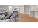 Comfortable living area showcasing neutral tones, wood floors and an open layout to the dining area at 5033 Wild Buffalo Ave, Las Vegas, NV 89131