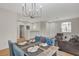 Open concept living and dining area featuring modern chandelier at 5033 Wild Buffalo Ave, Las Vegas, NV 89131