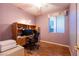 Bedroom featuring hardwood floors, desk with shelves, window and ceiling fan at 5332 Polo Grounds St, Las Vegas, NV 89148