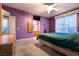Comfortable bedroom featuring neutral carpet, en-suite bathroom and soft natural light through window at 5332 Polo Grounds St, Las Vegas, NV 89148