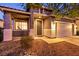 Inviting home exterior with stone landscaping, covered entry, and attached two-car garage at 5332 Polo Grounds St, Las Vegas, NV 89148