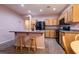 Well-lit kitchen with wood cabinetry, stainless steel appliances, and convenient breakfast bar at 5332 Polo Grounds St, Las Vegas, NV 89148