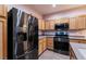 Close up of the kitchen featuring stainless steel appliances and natural wood cabinetry at 5332 Polo Grounds St, Las Vegas, NV 89148