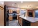 Open kitchen with stainless steel appliances, wood cabinets, and eat-in dining area with natural light at 5332 Polo Grounds St, Las Vegas, NV 89148
