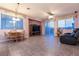 Bright living room with tile floors and a sliding glass door leading to the backyard at 5332 Polo Grounds St, Las Vegas, NV 89148
