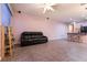 Open-concept living room with tile floors, ceiling fan, and access to kitchen and dining area at 5332 Polo Grounds St, Las Vegas, NV 89148