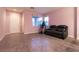 Living room with tile floors, pink walls, and a window providing natural light at 5332 Polo Grounds St, Las Vegas, NV 89148