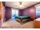 Spacious bedroom with carpet, ceiling fan, and sliding glass door leading to backyard at 5332 Polo Grounds St, Las Vegas, NV 89148
