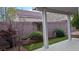 A cozy backyard featuring a covered patio, landscaped garden, and artificial turf, perfect for outdoor relaxation at 6339 Sharp Rock Ct, Las Vegas, NV 89139