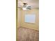 Neutral carpeted bedroom with ceiling fan and a window providing natural light at 6339 Sharp Rock Ct, Las Vegas, NV 89139