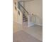 Hallway featuring carpeted stairs with black banister and tiled floors at 6339 Sharp Rock Ct, Las Vegas, NV 89139