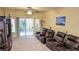 Relaxing living room boasting backyard view through a decorative security door and leather reclining sofas at 6339 Sharp Rock Ct, Las Vegas, NV 89139